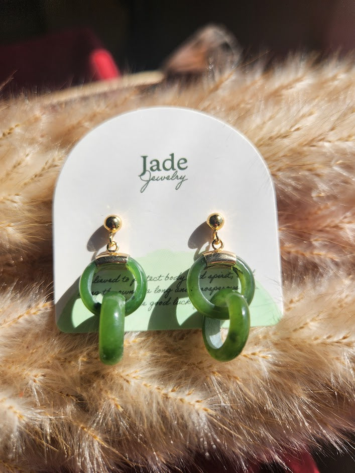 Green circular hoop earrings on a Jade Jewelry display card