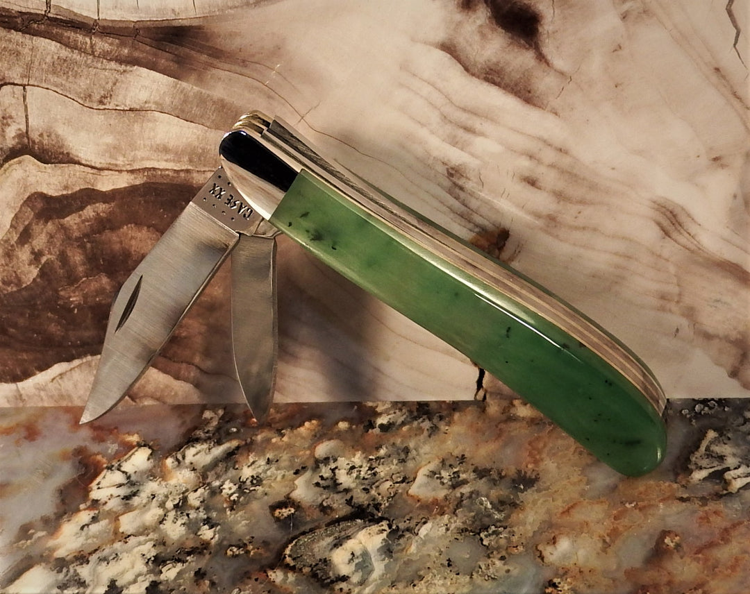 Ogden Jade Knife by Michael Hoover with green jade handle and blades spread over a speckled countertop with a handwritten note card in the foreground.