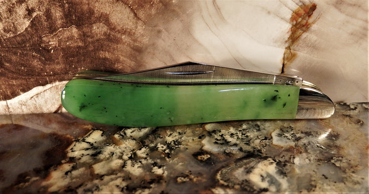 Ogden Jade Knife by Michael Hoover featuring jade handle and blades fanned along the spine on a marble surface.