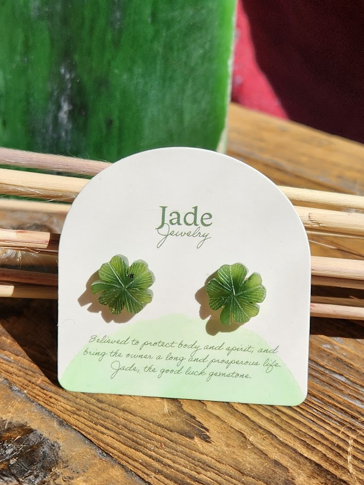 Green jade shamrock earrings displayed on a white card with Jade Jewelry branding.
