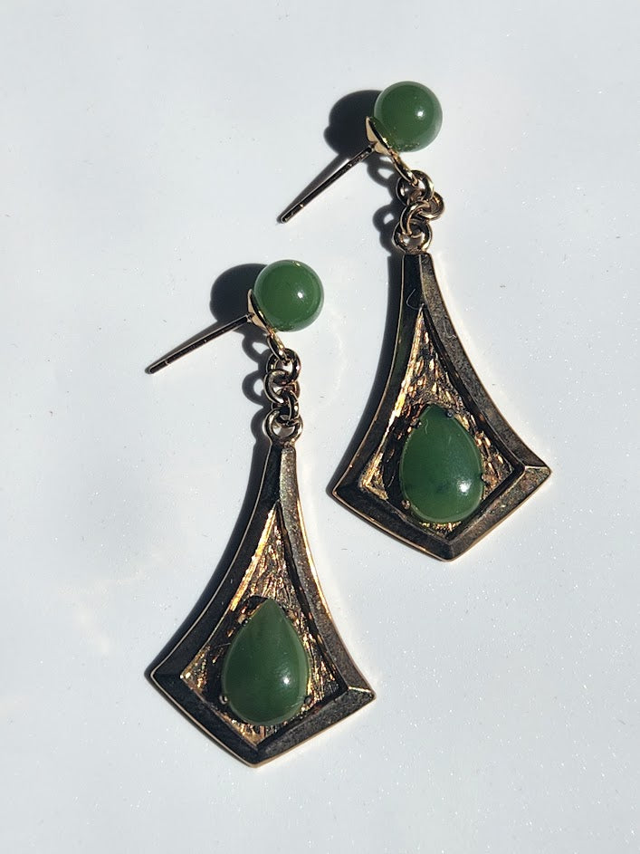 Close-up of Vintage Jade Drop Earrings featuring green jade beads and teardrop stones in a gold-tone frame on a white background