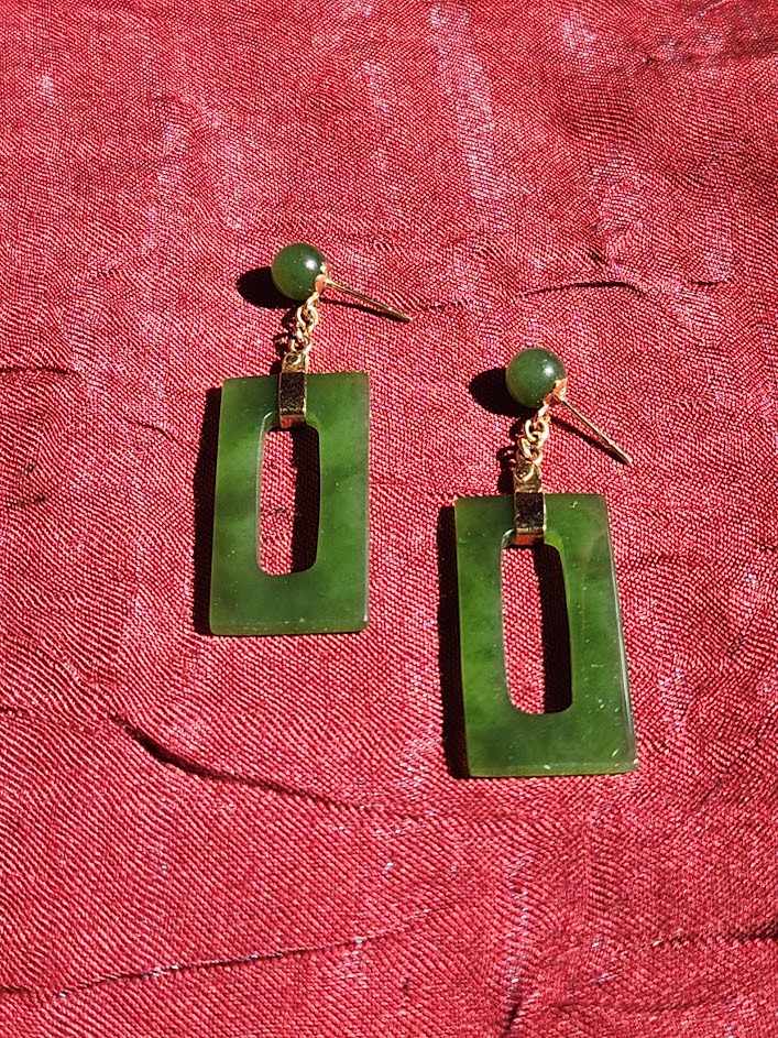 Vintage jade rectangle drop earrings with round bead tops displayed on a white card against red fabric.