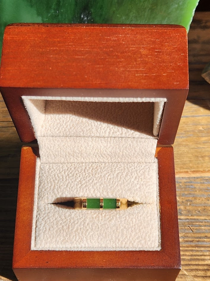 Vintage jade ring in a wooden jewelry box with white velvet interior.
