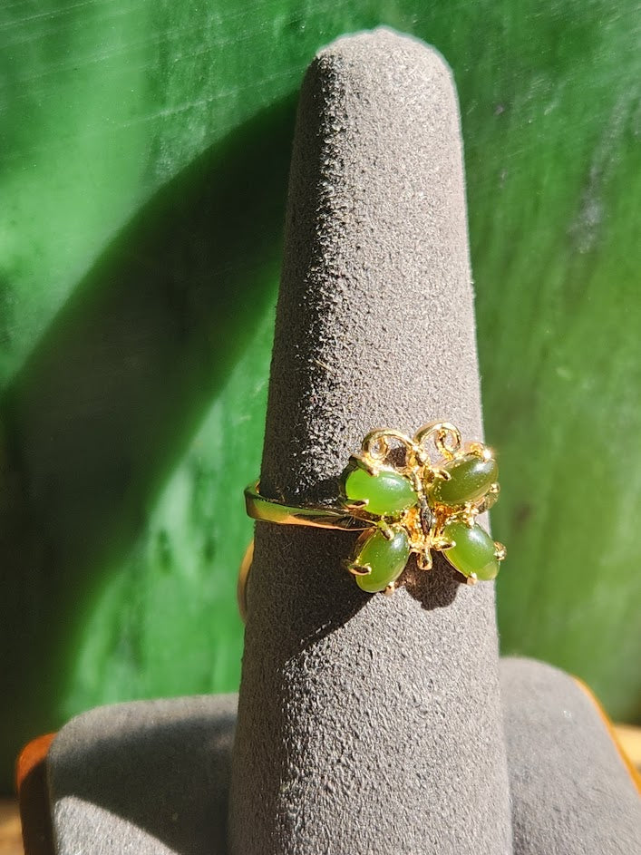 Vintage Jade Butterfly Ring displayed on a gray ring cone against a green backdrop