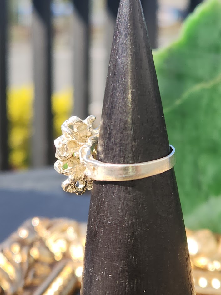 Side view of Vintage Jade Medusa ring with green jade and sculpted gold cluster on a cone display