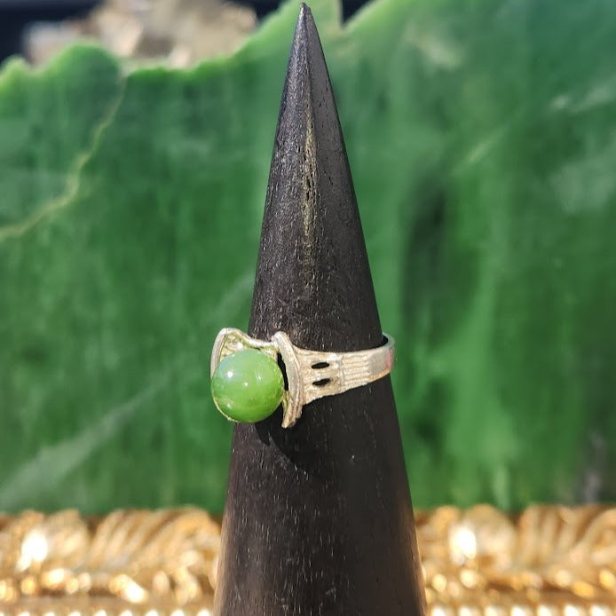 Close-up of the Silver Canadian Jade Star Ship ring with a green jade sphere in decorative prongs.