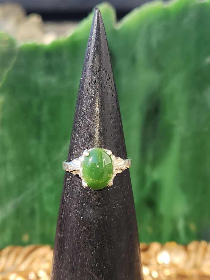 Canadian Jade Ring on a black ring cone showing green jade cabochon and textured silver band.
