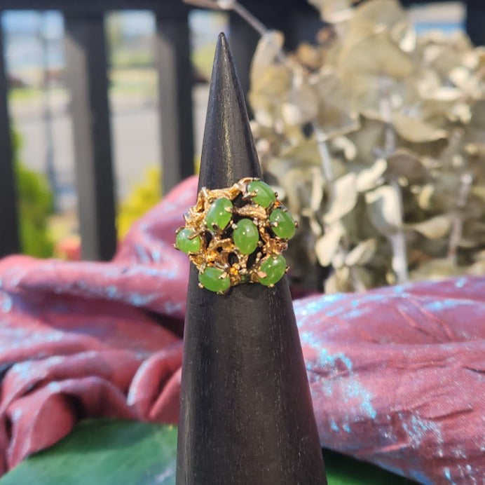 Vintage Jade Power Ring featuring a cluster of green jade beads set in gold on a display cone.