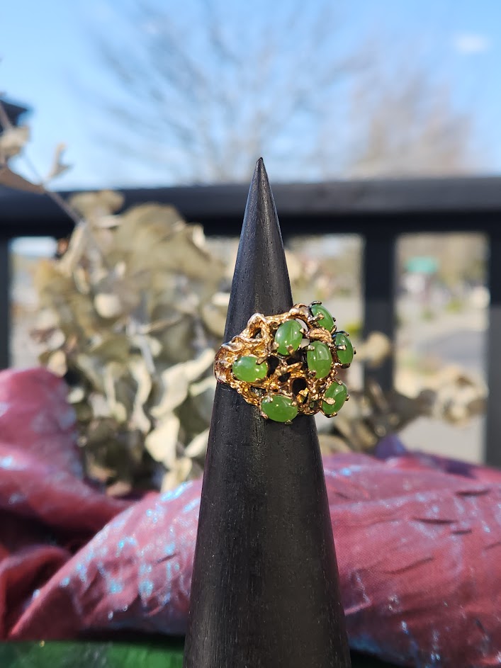 Close up of Vintage Jade Power Ring showing green jade beads arranged in a leafy gold cluster.
