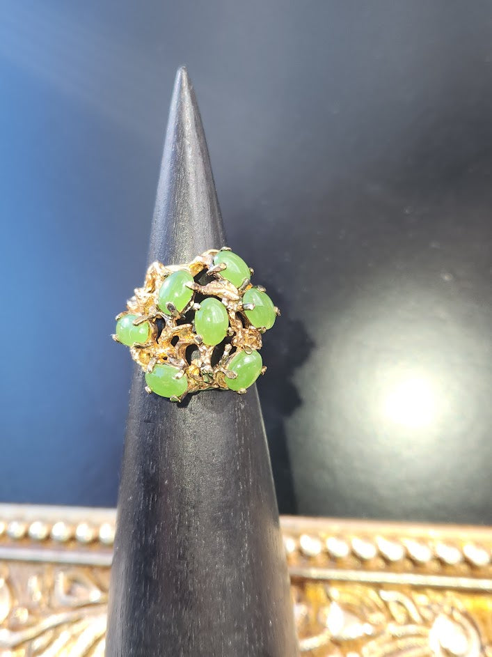 Vintage Jade Power Ring with green jade beads in a gold network against a dark backdrop.