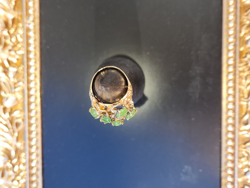 Vintage Jade Power Ring with a large dark central stone and a cluster of green jade beads on an ornate gold band