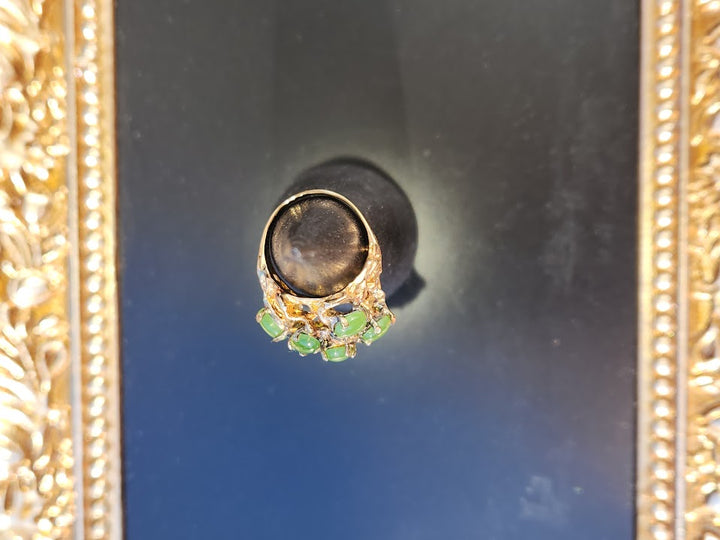 Vintage Jade Power Ring with a large dark central stone and a cluster of green jade beads on an ornate gold band