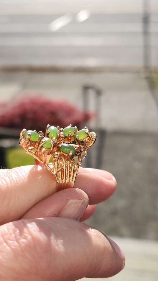 Gold tone vintage jade ring with a cluster of green cabochons arranged like a floral bouquet.
