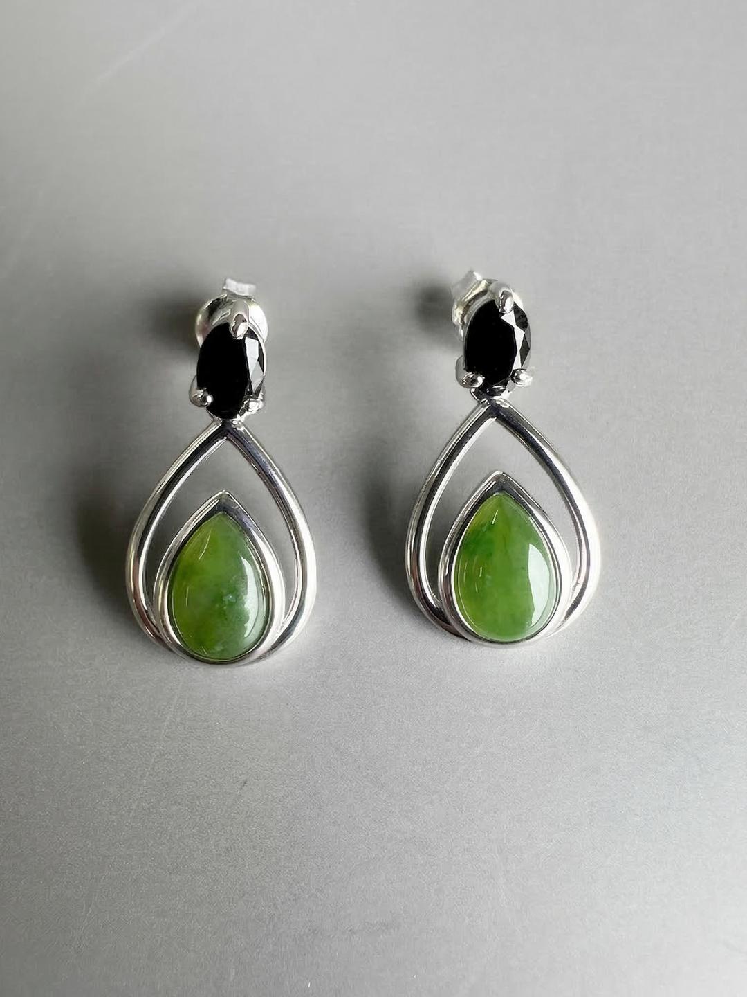 Canadian nephrite jade silver teardrop earrings featuring green jade centers within double silver teardrop frames.