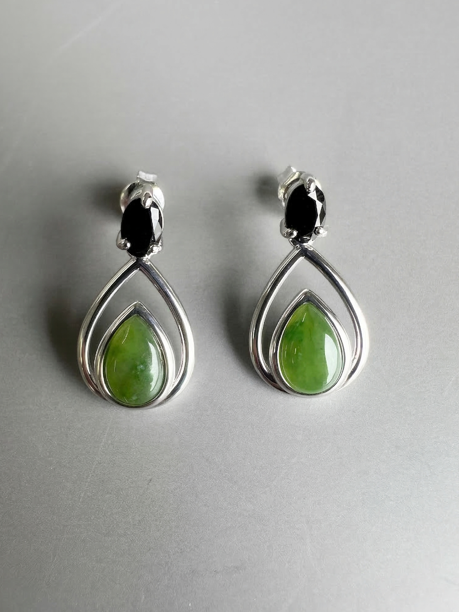 Canadian nephrite jade silver teardrop earrings featuring green jade centers within double silver teardrop frames.