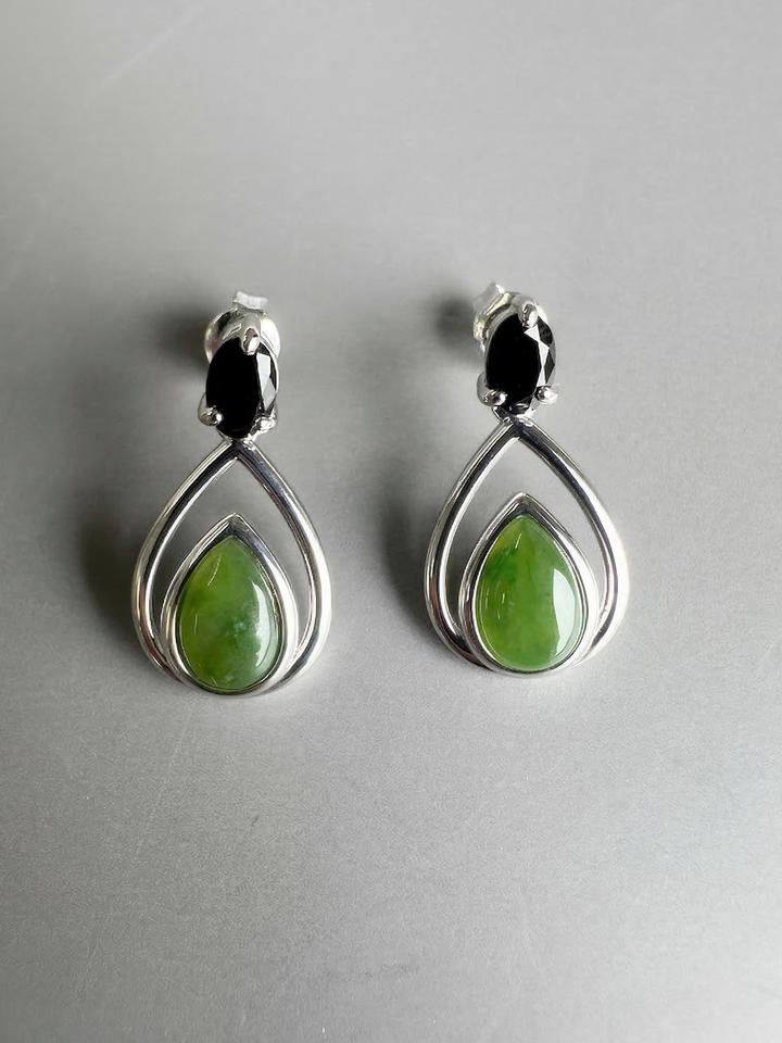 Canadian nephrite jade silver teardrop earrings featuring green jade centers within double silver teardrop frames.