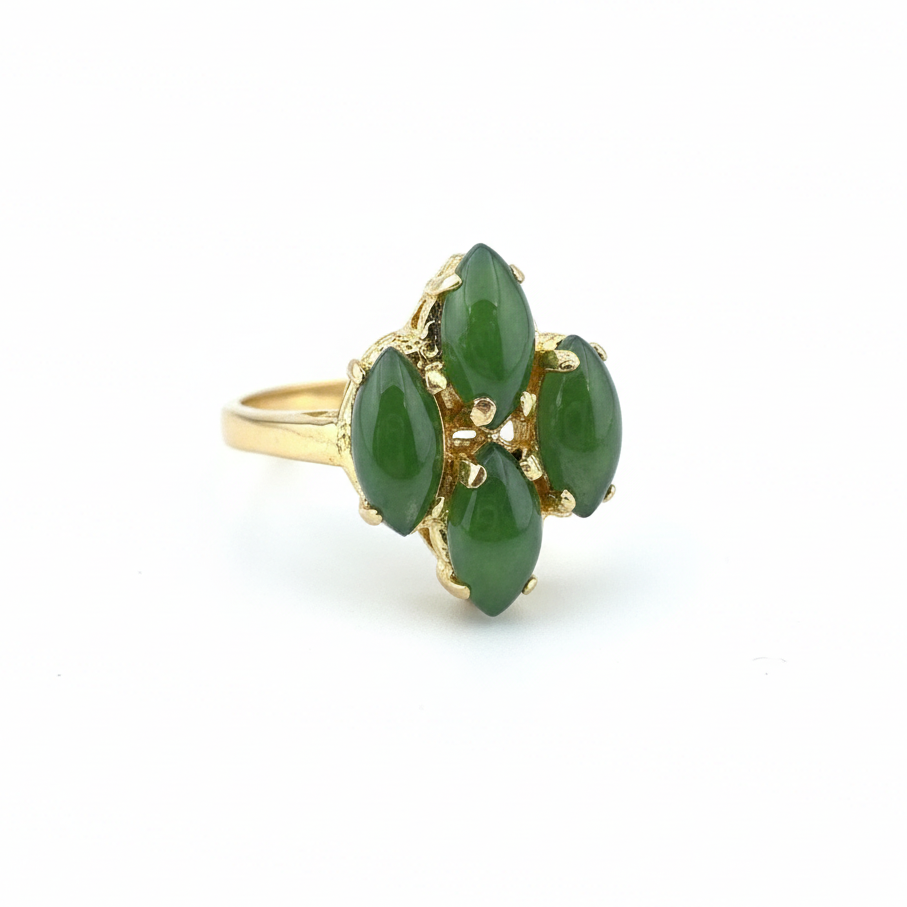 Gold ring with a floral cluster of five green jade marquise stones set in gold.