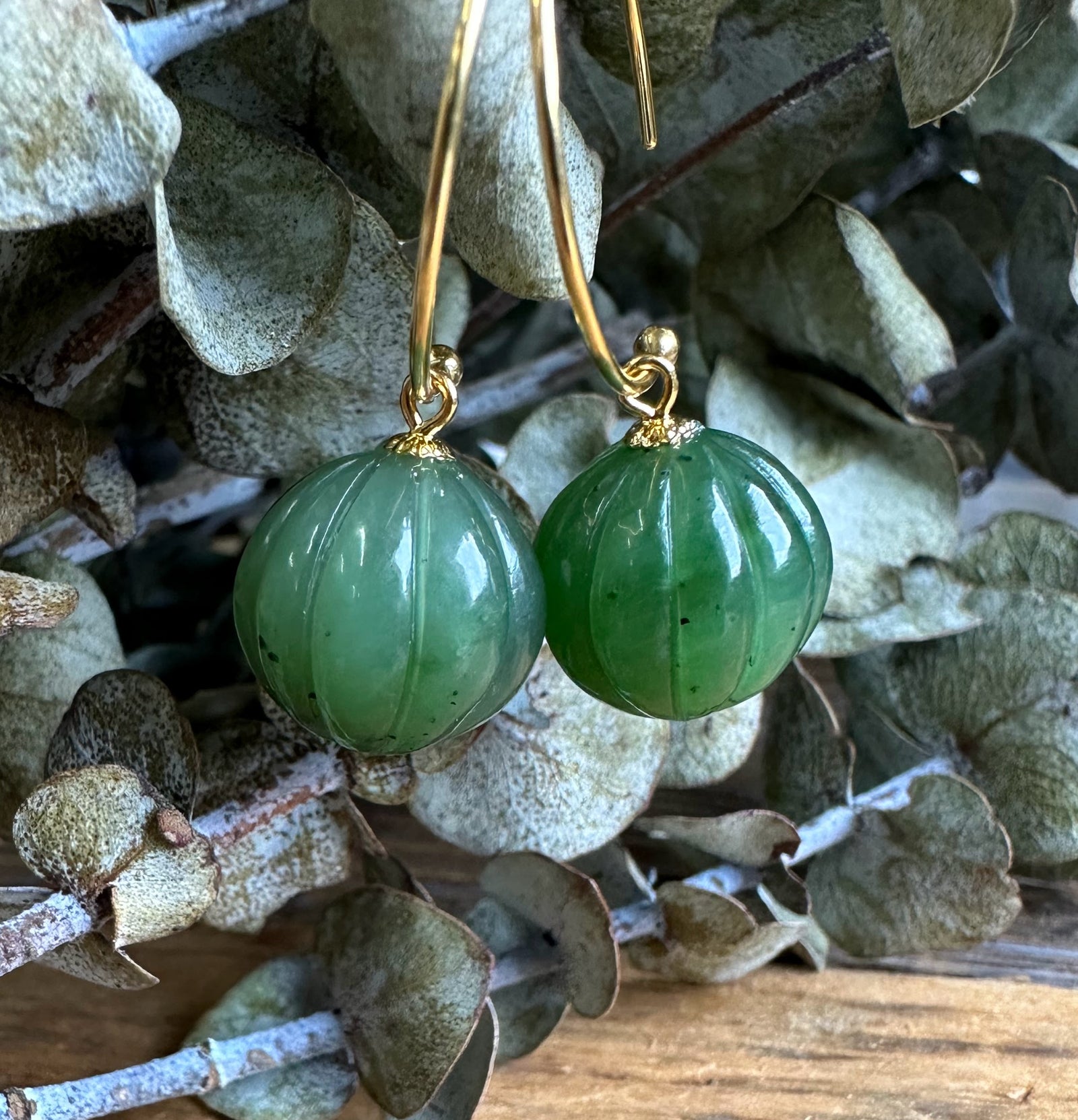 Green jade drop bead earrings 13mm with gold curved hoops.