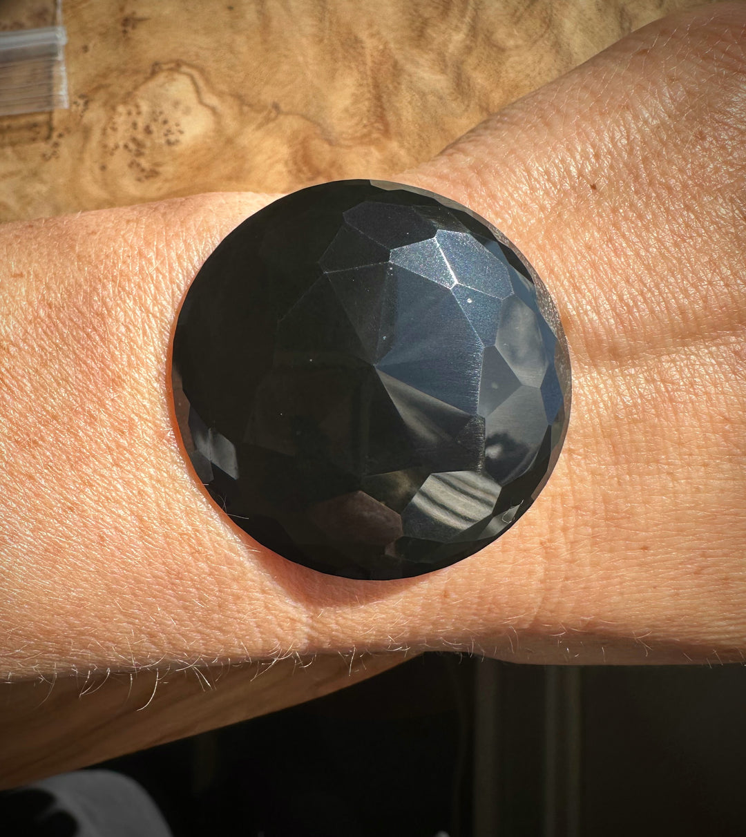 Faceted black stone on a person&