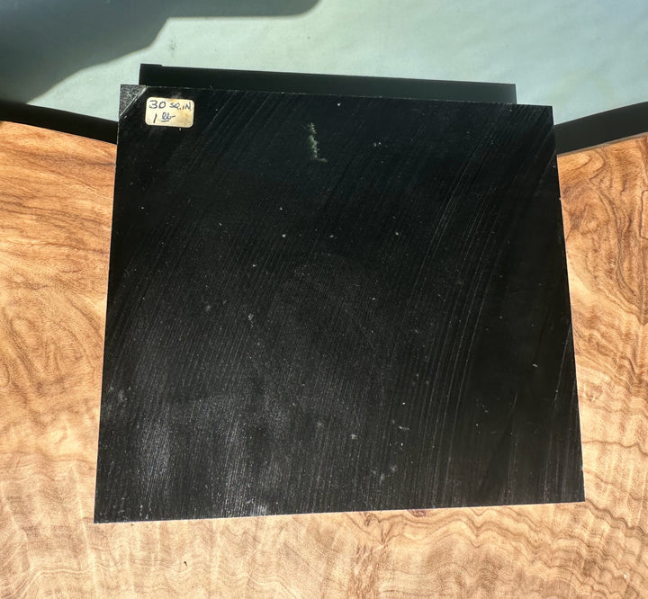 Wyoming Jade Slab lying on a wood surface with a small beige label in the upper left corner