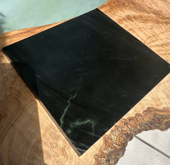Wyoming Jade Slab 425 g dark green to black with faint veining resting on a rustic wood slab