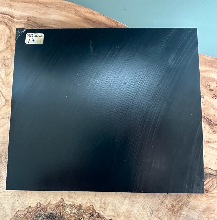 Wyoming Jade Slab 425 g glossy black panel with brushed lines and a corner label visible on the top left
