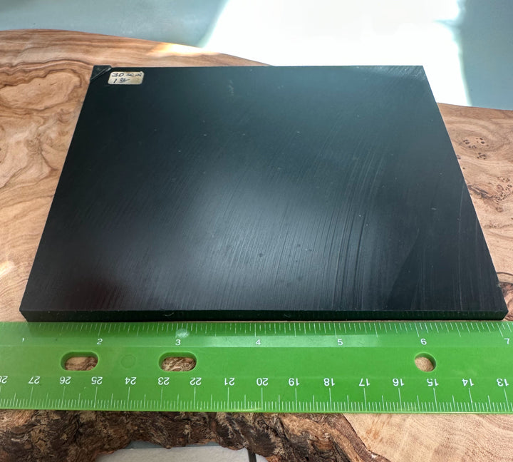 Black Wyoming Jade Slab weighing 425 grams resting on a wooden surface with a green ruler at the front.