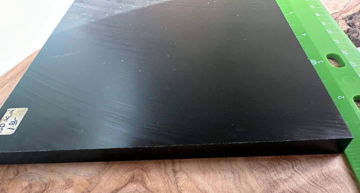 Wyoming Jade Slab in black with a bright green ruler along the right edge for scale.