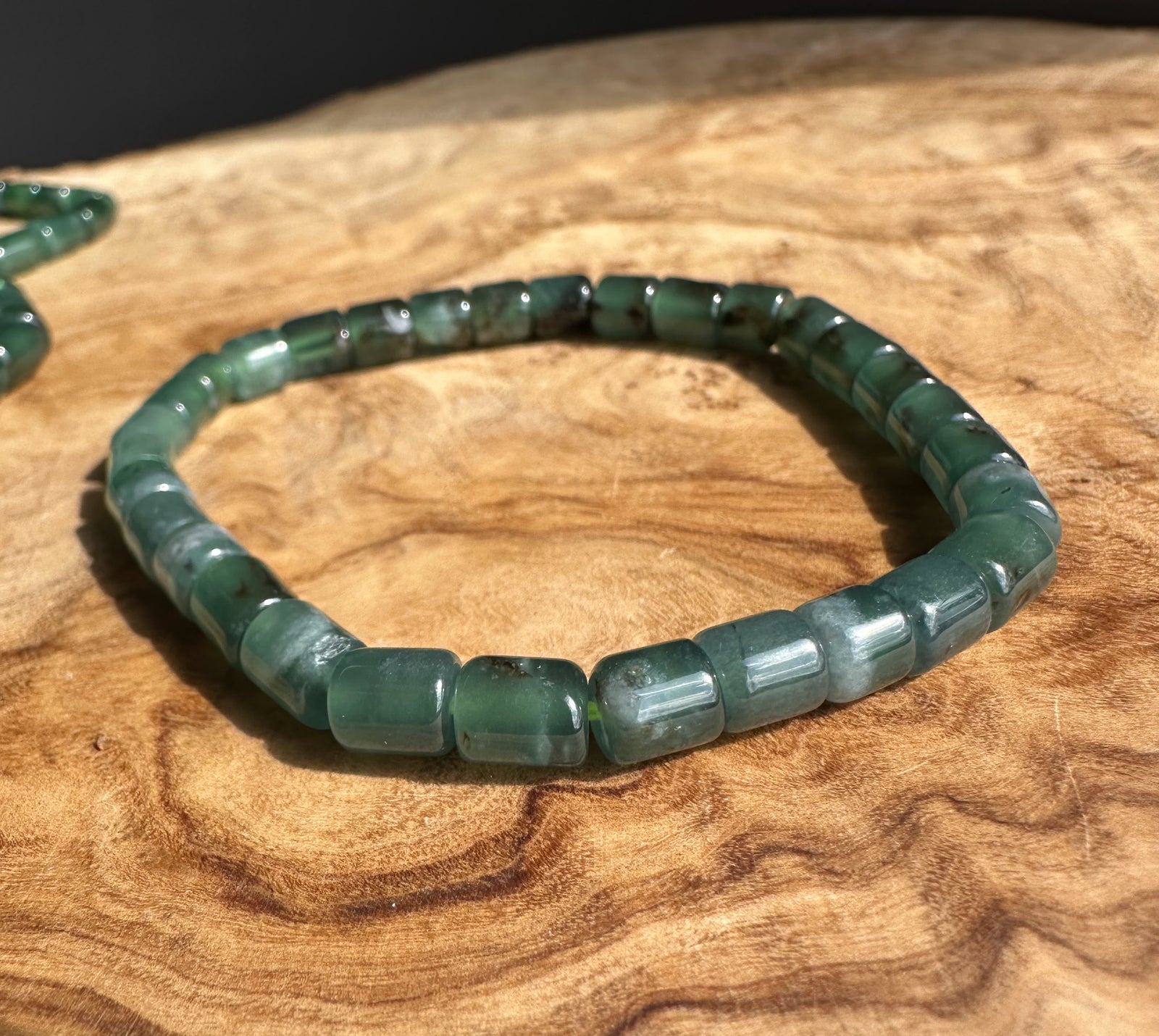 Blue Green beaded bracelet on a wooden surface