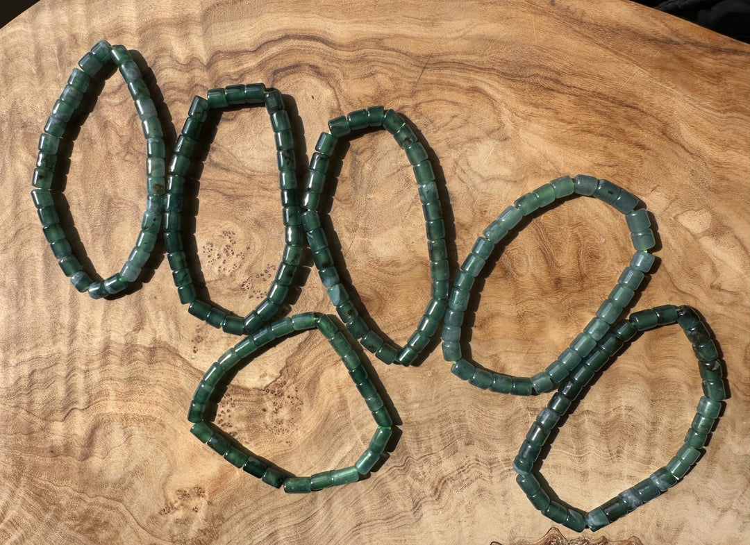 Green Blue jadeite beads on a wooden surface