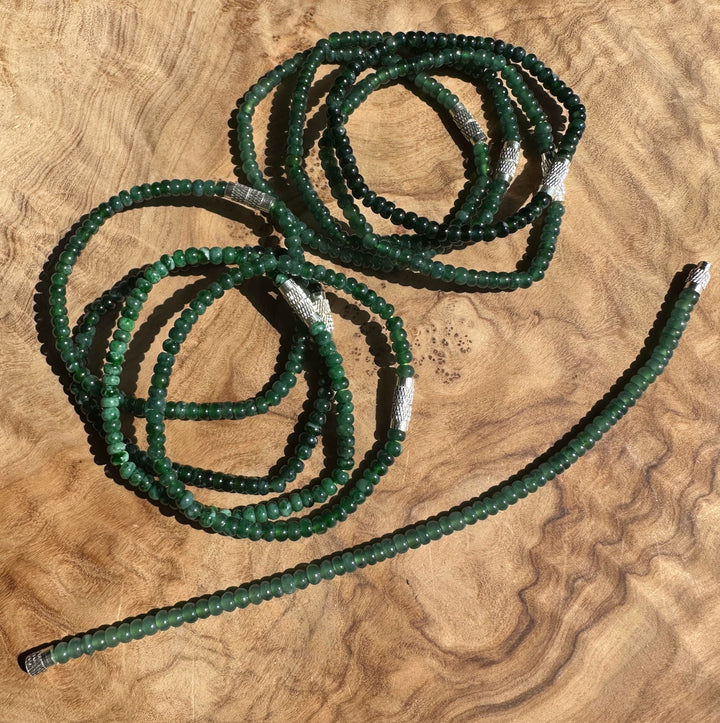 Green beaded bracelet on a wooden surface