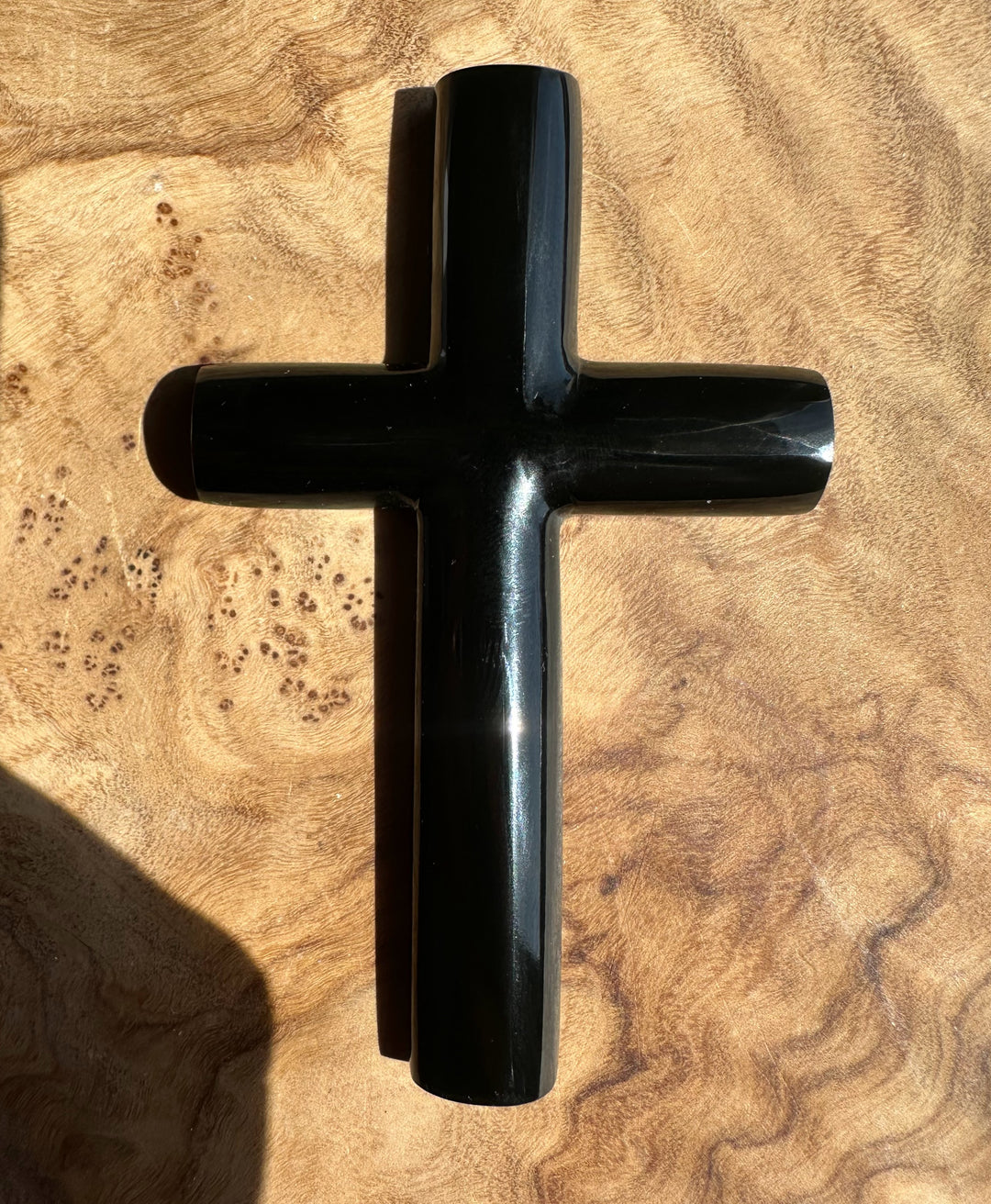 Black cross on a textured beige surface