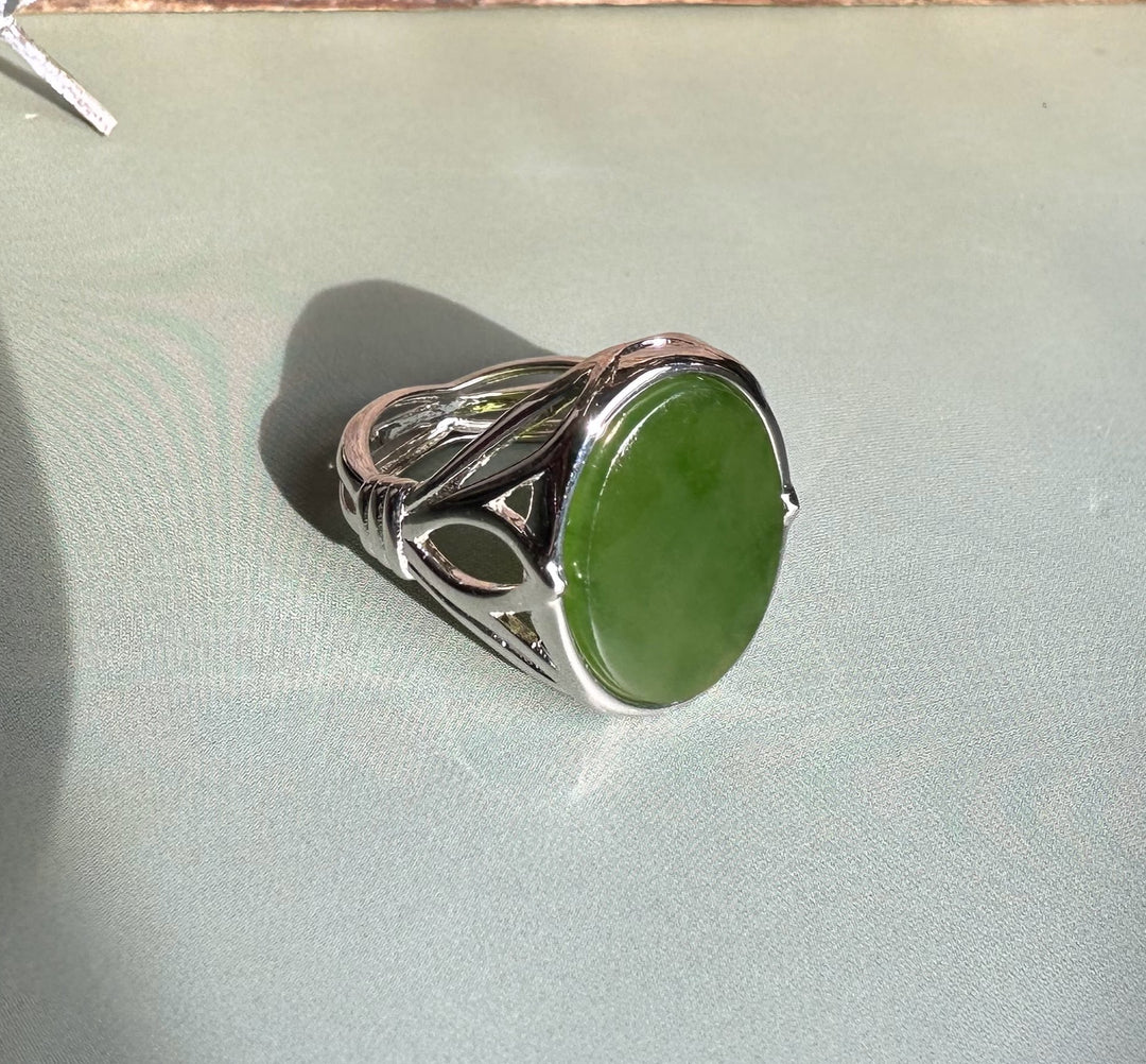 Side view of the Canadian Jade Silver Ring with its oval green jade and intricate metalwork