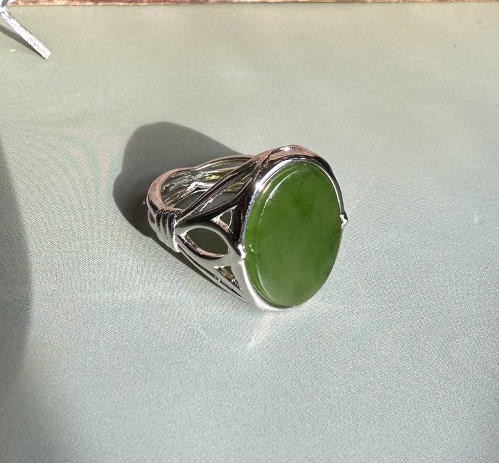 Side view of the Canadian Jade Silver Ring with its oval green jade and intricate metalwork