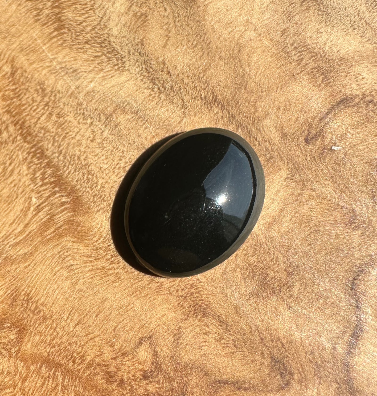 Black jade on a textured beige surface