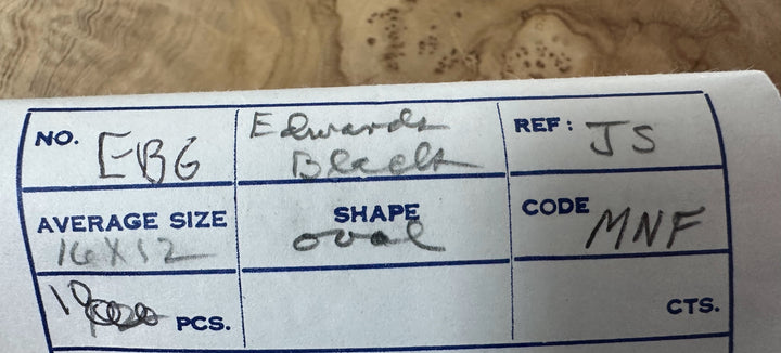 Label with handwritten text on a wooden surface