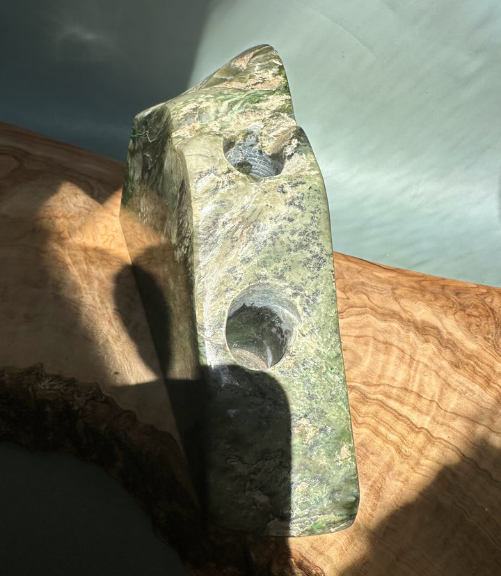 Green jade candle holder specimen with a circular hole on its side