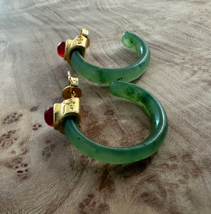 Green jade hoop earrings with gold caps and a red bead accent
