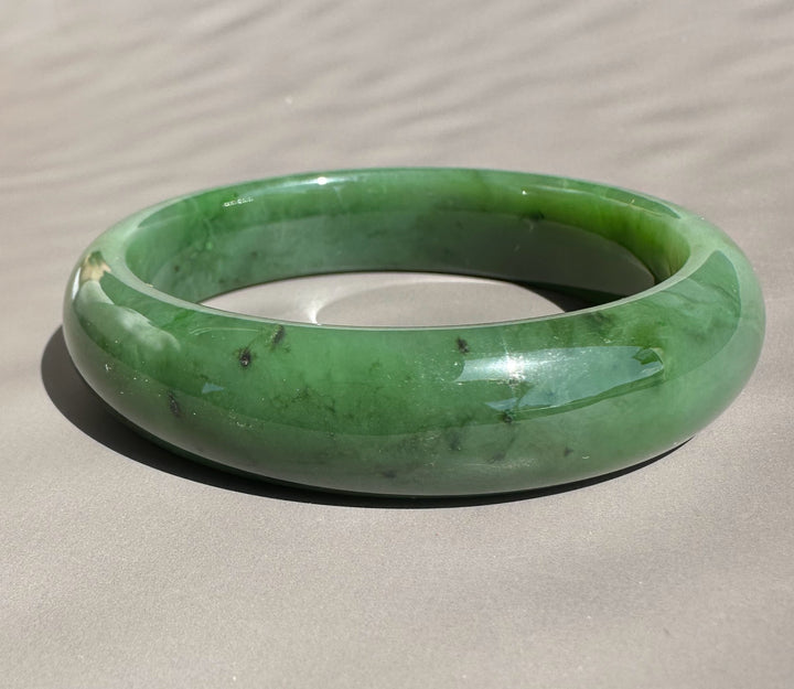 Canadian Jade Bangle 58 x 15mm dark green with natural color variations and polished surface