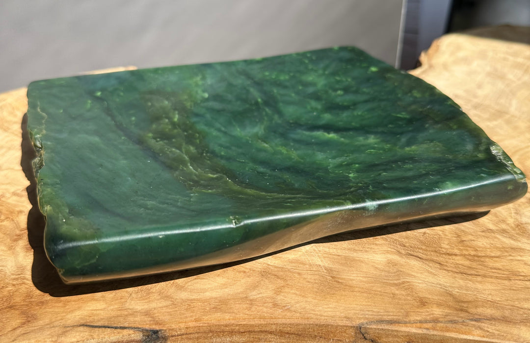 Green jade on a wooden surface with a neutral background
