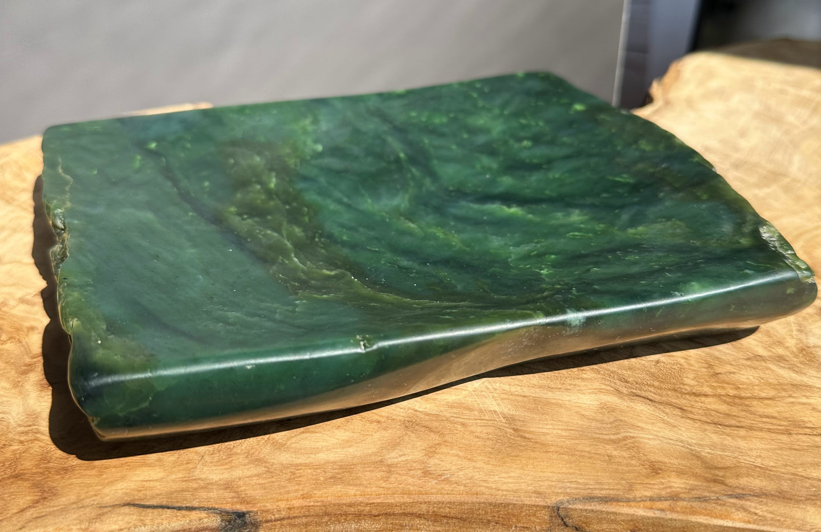 Green jade on a wooden surface with a neutral background
