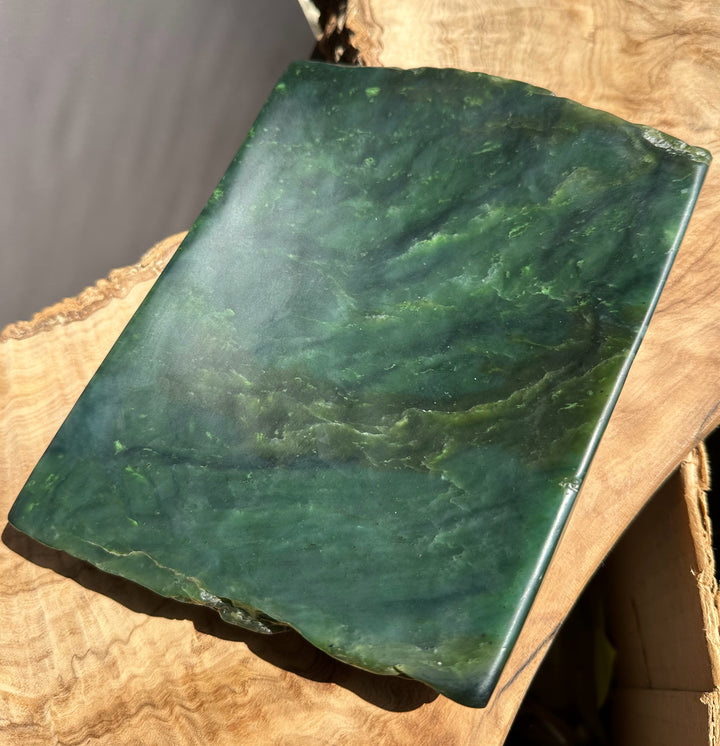Green stone slab on a wooden surface