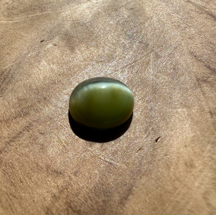 Green stone on a WOODEN surface