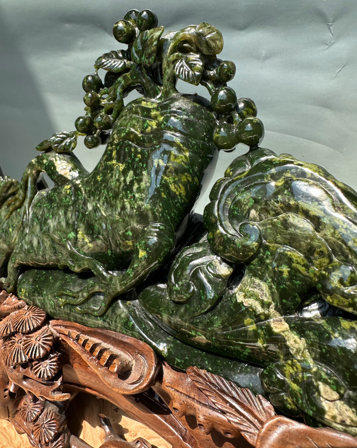 Green jade Cassiar sculpture close up highlights the knotty tree canopy with glossy leaf patterns on the reclining form.