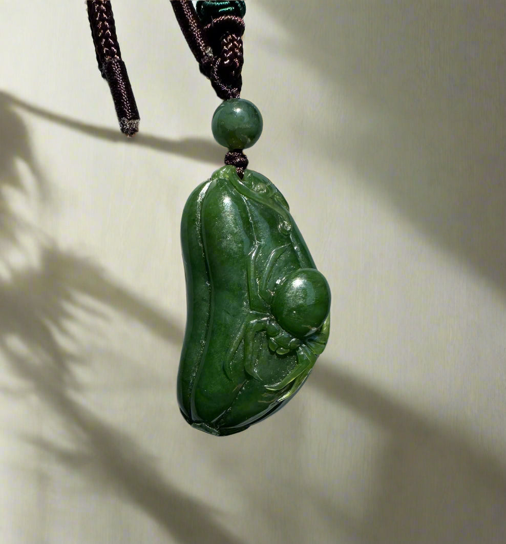 Canadian jade Spider and Gourd Pendant carved from green jade on a dark braided cord