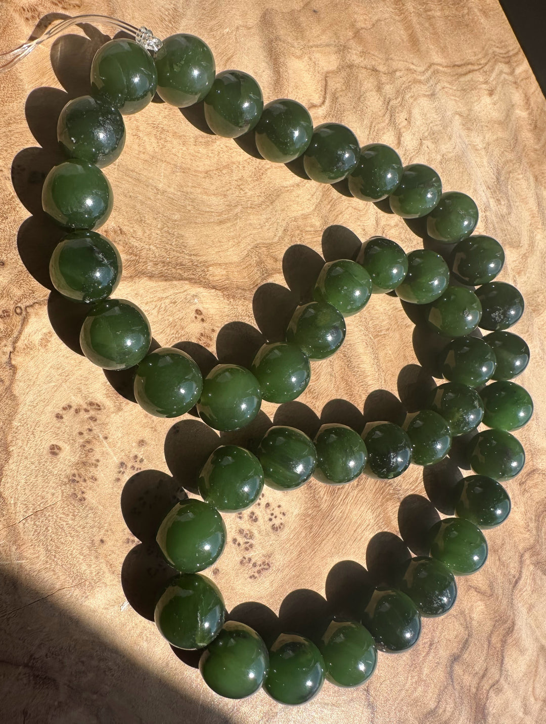 Green beaded on a wooden surface
