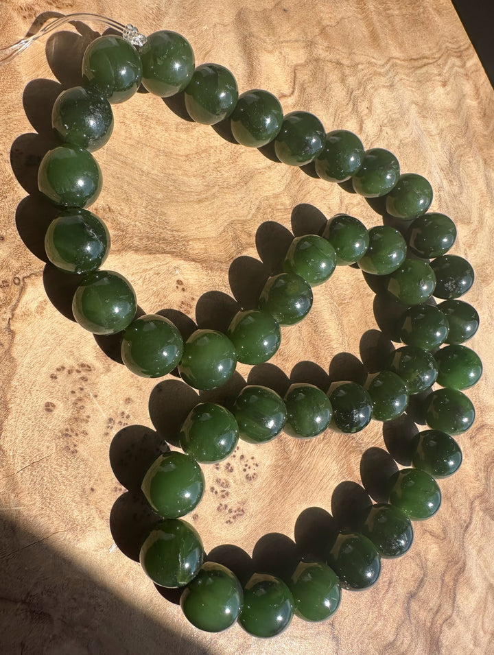 Green beaded on a wooden surface