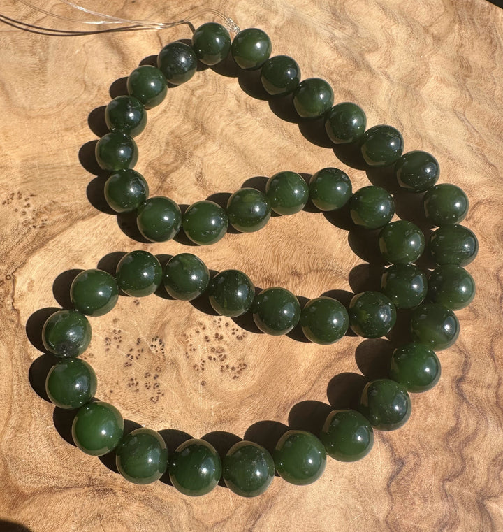 Green beads on a wooden surface