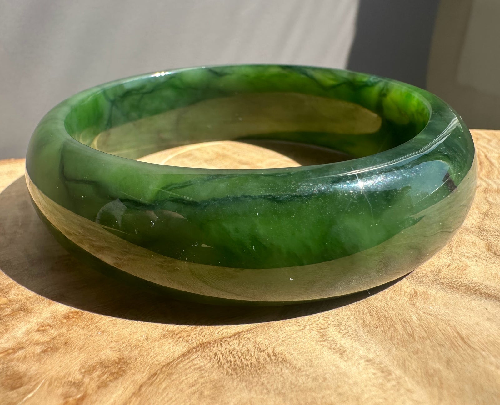 Green  bangle on a wooden surface