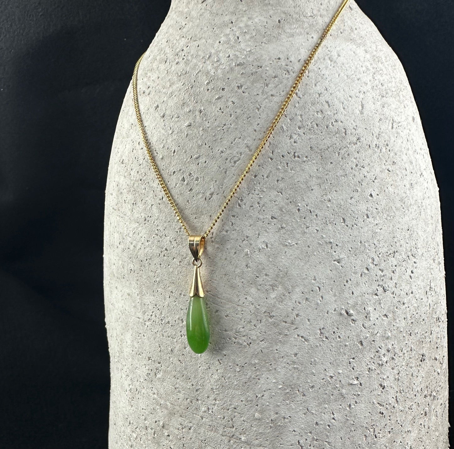 Vintage Teardrop Pendant 31mm on a gold chain necklace shown on a gray display bust.
